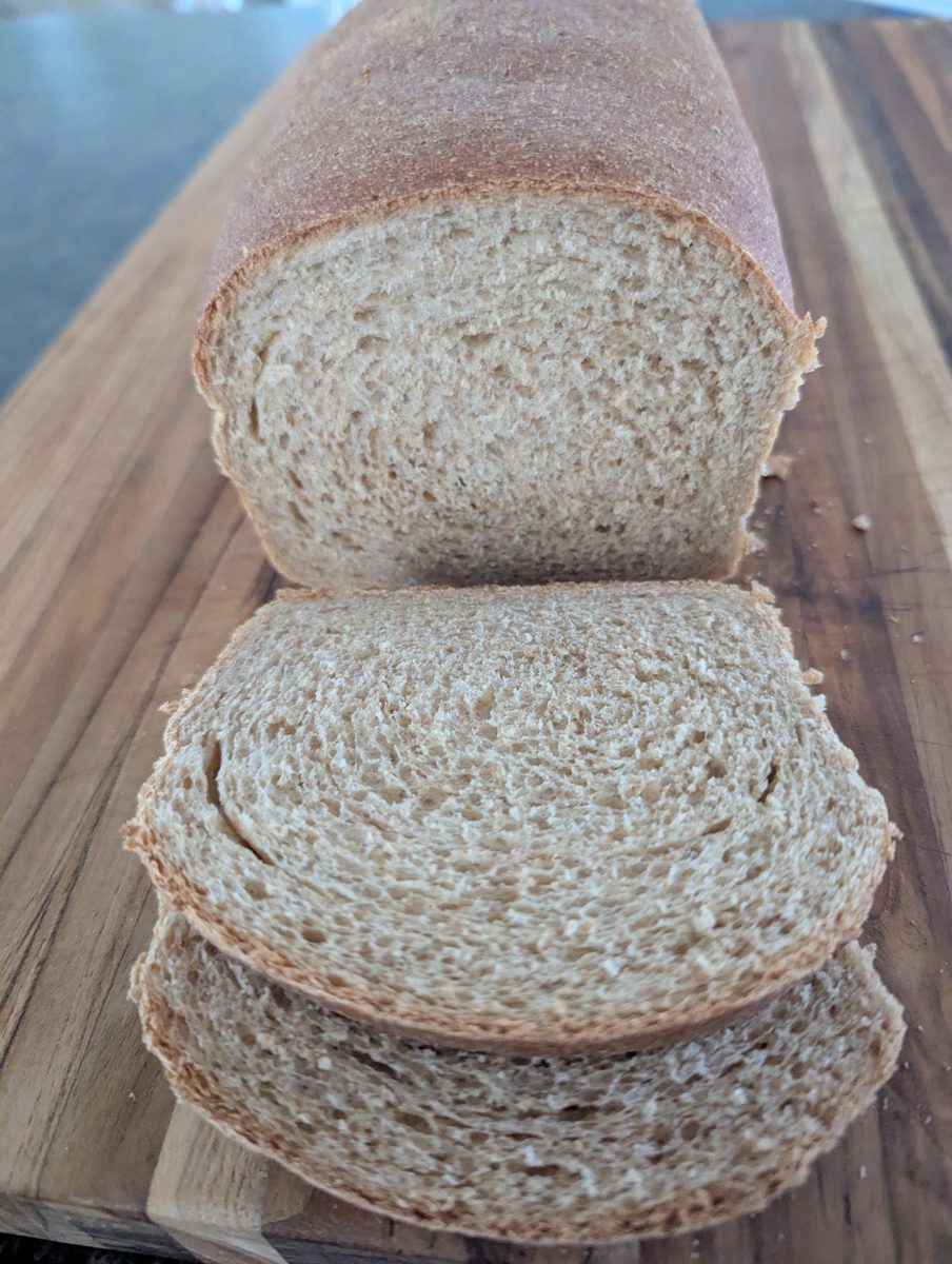 A sliced freshly milled loaf showing a soft, even crumb